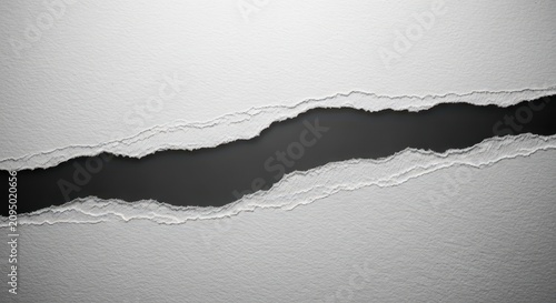 A macro shot of thick white textured paper showing a jagged irregular tear through the center against a contrasting dark grey background, isolated, fragment, torn