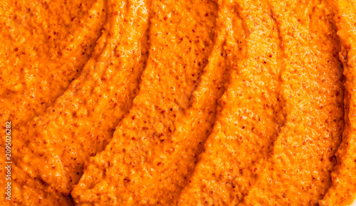 Orange yogurt ice cream with fresh fruits and berries, papaya, grapefruit, pumpkin, persimmon. Smoothie texture. Fruit yogurt ice cream. Delicious sweet dessert close-up as a background.