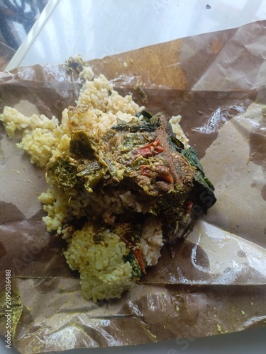 Aftermath of a casual meal, with food scraps and remnants on a crumpled paper wrapper, depicting consumption waste
