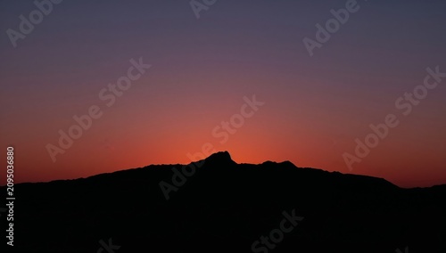 Sunset Over Mountain Range in the Evening Sky With Purple and Orange Colors