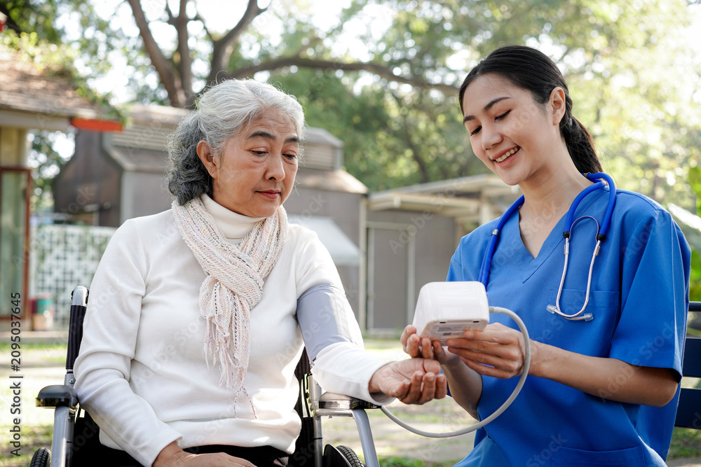 Fototapeta premium A woman in a white shirt is being checked by a nurse