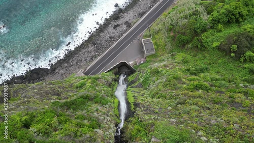 Static top down aerial view of Agua d'Alto waterfall, coastal highway and ocean