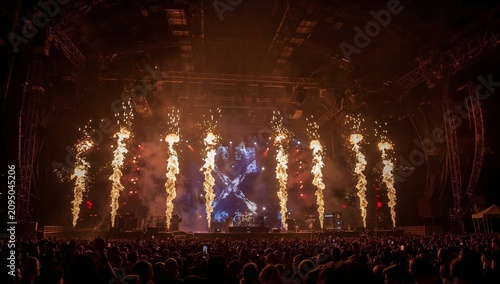 Fireworks Light up the Stage During a Concert While Crowd Enjoys the Music in...