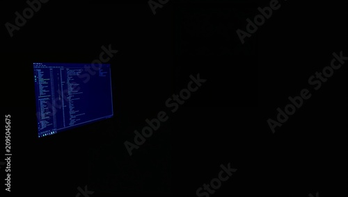 Person Sits in Front of Computer Screen With Code During Late Night Hours