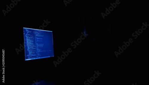Person Sits in Front of Computer Screen With Code During Late Night Hours