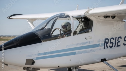 Pilot Prepares for Flight in Small Aircraft on a Clear Day at the Airfield