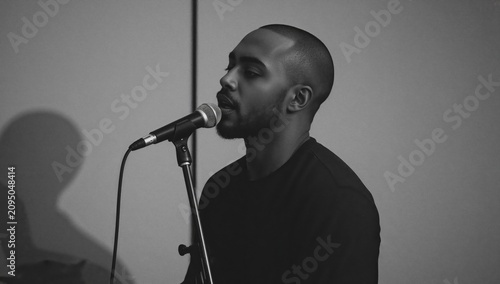 Singer Performs at a Small Venue During an Evening Show in Front of an Engage...
