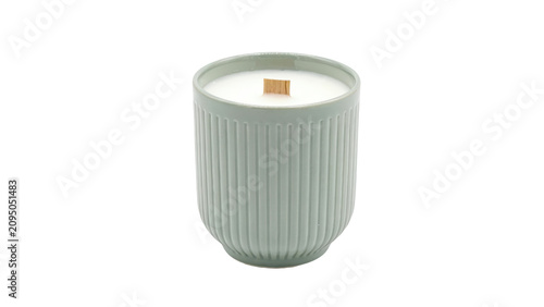 A sage green ceramic candle with a wooden wick inside a ribbed container for home decor on transparent background