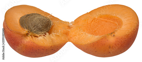 Obraz na plátně Ripe apricot broken in half with pit on isolated background