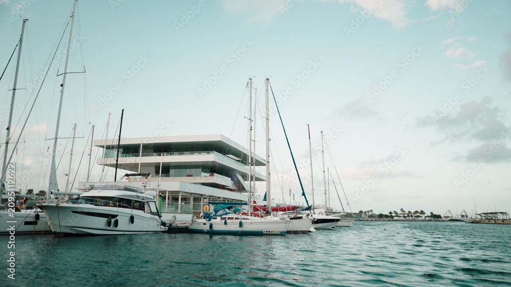 Fototapeta premium Veles e Vents building rising among boats in Valencia marina