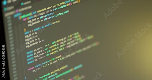 Close up of С++ programming code scrolled on the monitor. Warm IDE colors.