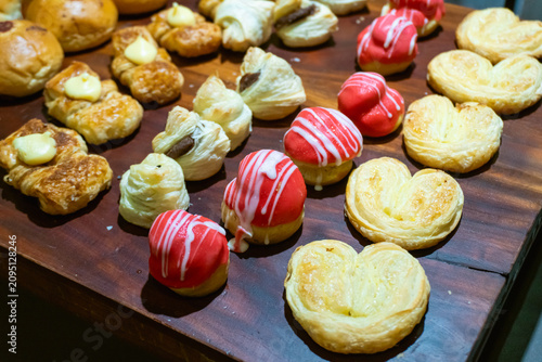 Canvas Print Golden pastries rest on a wooden board