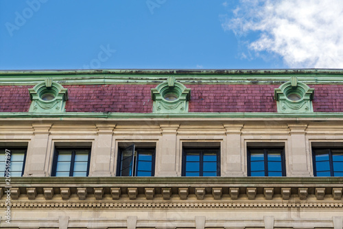 Photos Upper facade of a historic apartment building with a purple mansard roof in Bost