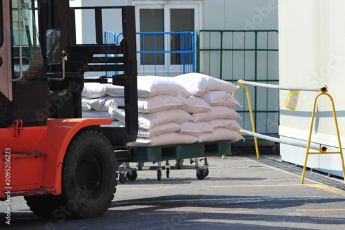 carrying rice bag by forklift