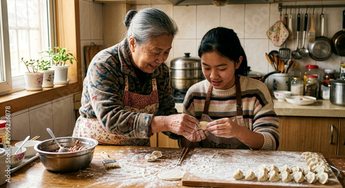 Asian Grandmother Teaching Teenage Granddaughter to Make Homemade Dumplings in Cozy Kitchen