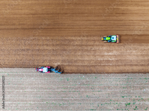 In spring, farmers use farm machinery to grow peanuts