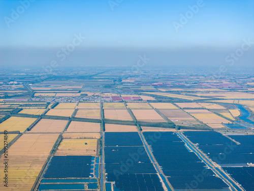 Bild auf Leinwand Village, fishpond, solar photovoltaic panels and paddy fields