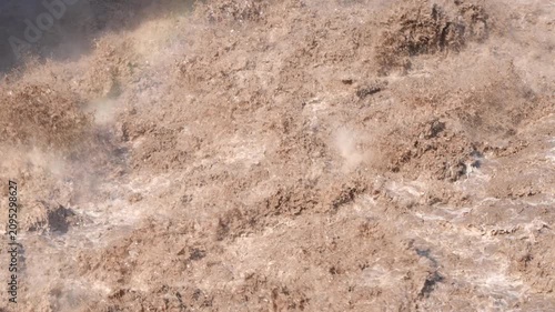 A slow-motion close-up of raging floodwaters