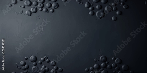 Photography Microscopic view of dark gray circular cellular structures clustered against a darker, textured background, creating an abstract scientific composition