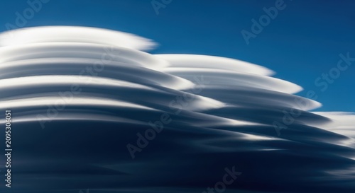 High Altitude Lenticular Clouds Layered in Blue Sky