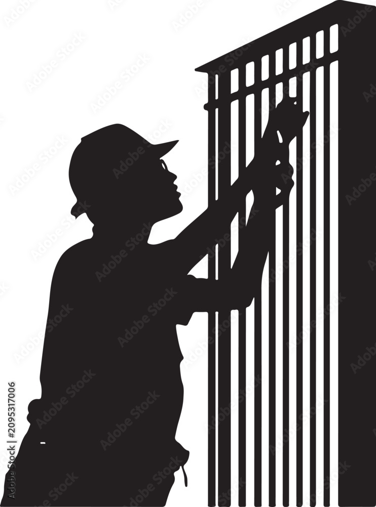 Obraz premium Silhouette of a man in a cap, painting a metal gate