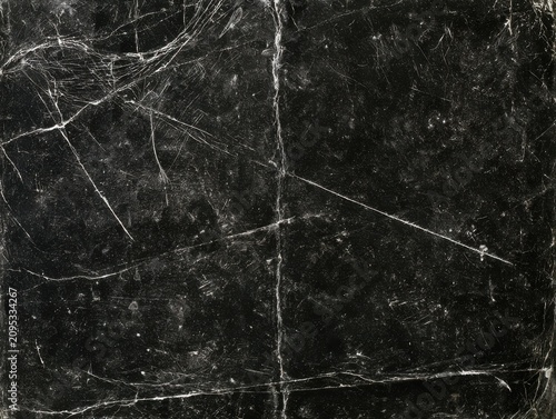 Distressed black paper texture background with white creases and scratches for worn antique vintage dark poster backdrop