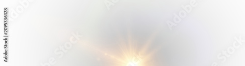 Fotografie Soft golden sunburst flare with subtle light rays on white background