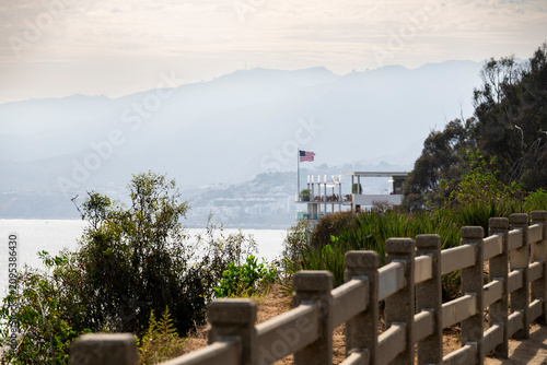 Coastal view with American flag and modern building overlooking the ocean