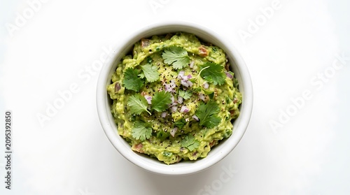 Delicious guacamole, creamy avocado dip, green healthy snack, bowl of fresh herbs