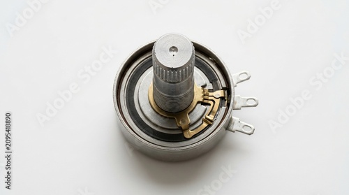 Electronic rotary potentiometer component on white background.