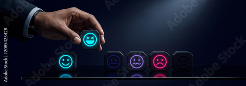 Hand choosing a happy face icon. Customer experience feedback concept with glowing emotion symbols.