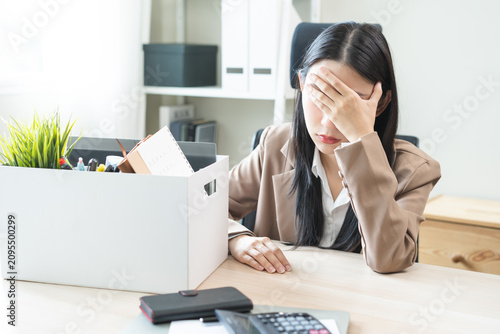 Canvastavla Unemployed, quite job, desperate asian young businesswoman resigning from company packing belongings, stuff in box cardboard, layoff or leaving, changing work