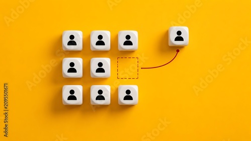 White cubes with human icons on yellow background where one figure moves out of the group representing promotion or leaving