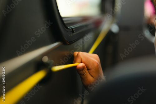 Passenger pulling bus stop request cord while riding the city bus