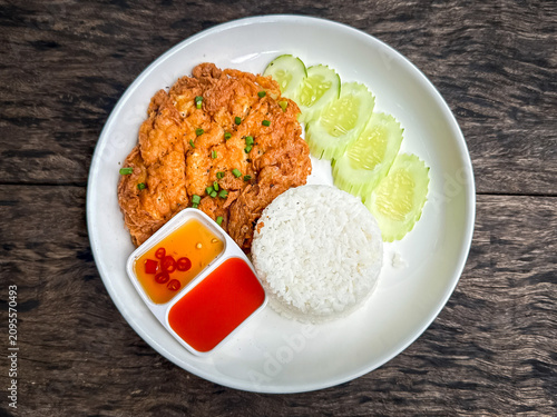 Crab omelet with rice on the wood table
