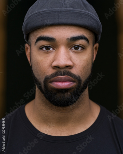 Close Up Portrait of Smiling Black Man Wearing Knit Cap and Black T Shirt