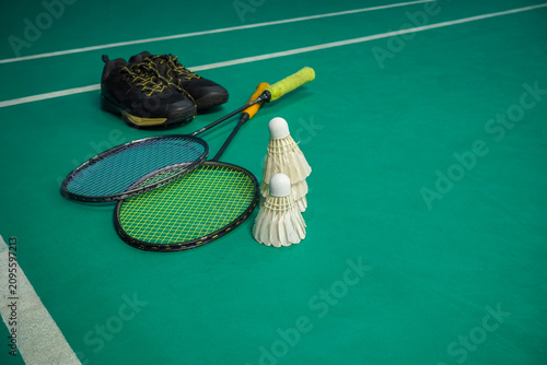 Badminton Rackets Shuttlecocks and Sports Shoes on Court