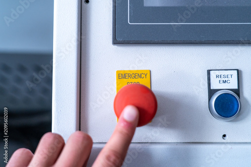 Fotografía Activating red emergency stop button on industrial control panel, ensuring safet