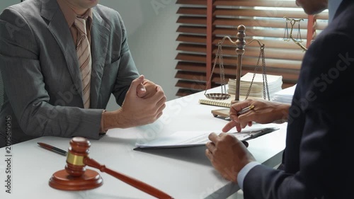 Lawyer providing legal advice to client in law firm office
