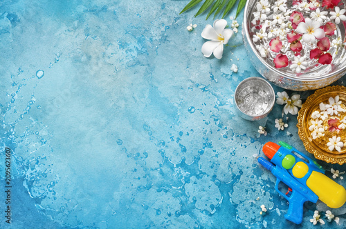 Songkran Festival Background with Traditional Silver Bowls, Flowers and Copy Space