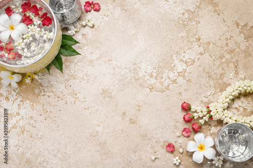 Songkran Festival Background with Traditional Silver Bowls, Flowers and Copy Space