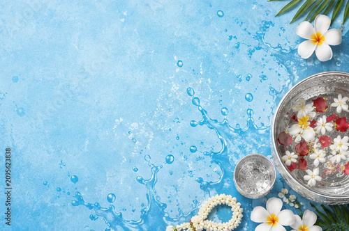 Songkran Festival Background with Traditional Silver Bowls, Flowers and Copy Space