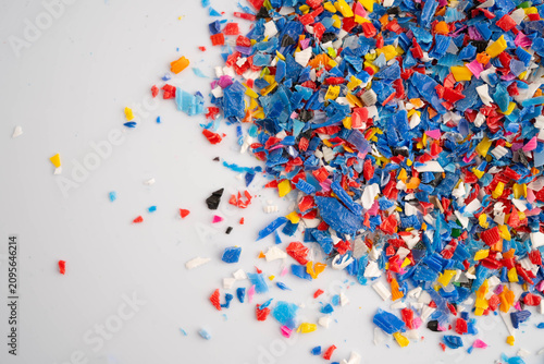 Fotografie Plastic colorful pieces recycling shredded for industrial use.