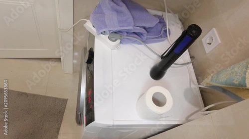 Top View of a Shaking Washing Machine Vibrating Loudly During Spin Cycle in Laundry Room