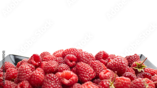 Fresh red raspberries piled in a black dish with a white background, showcasing their vibrant color and texture, ideal for culinary and health-related imagery