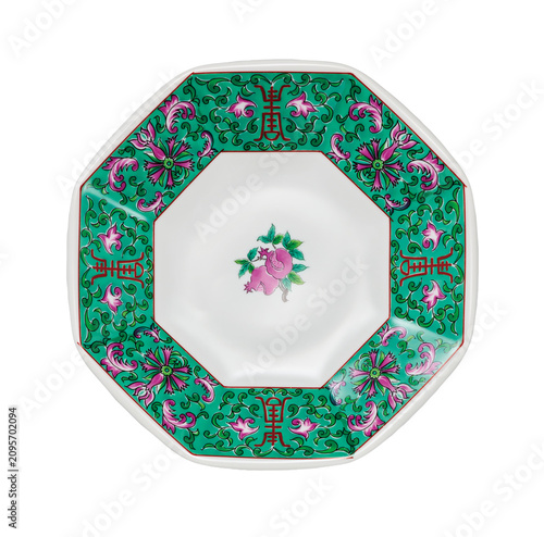 Octagonal green and purple floral porcelain plate isolated on white background
