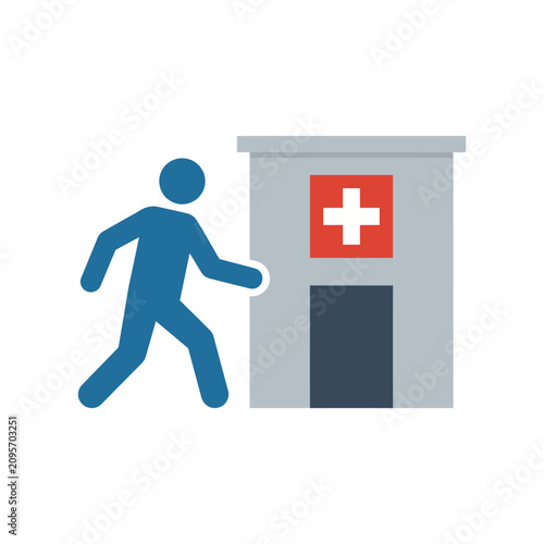 Person walking towards a building with a red cross symbol, representing healthcare access or hospital visit