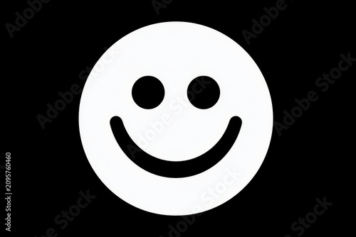 White smiley face glowing on solid black background in sharp focus minimalist macro shot for social media marketing