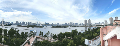 Schilderij op canvas Tokyo Bay panorama with the iconic Rainbow Bridge and Tokyo Tower under a blue s