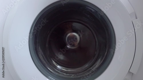 Close-up of washing machine drum spinning quickly